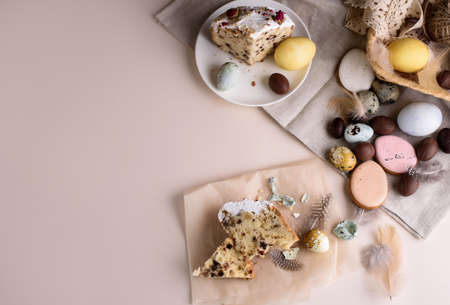 Beautiful Easter composition of eggs with natural colors, gingerbread, flowers, feathers. Holiday content.の写真素材