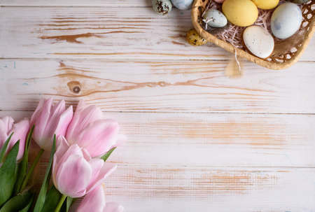 Beautiful Easter composition of eggs with natural colors, gingerbread, flowers, feathers. Flat layの写真素材