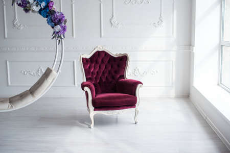 Beautiful decor of a swing of flowers, beautiful armchairs for a photo. It's a beautiful room with flowers.の写真素材