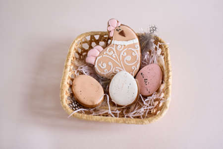 Beautiful Easter composition of eggs with natural colors, gingerbread, flowers, feathers. Holiday content.の写真素材