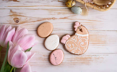 Beautiful Easter composition of eggs with natural colors, gingerbread, flowers, feathers. Holiday...