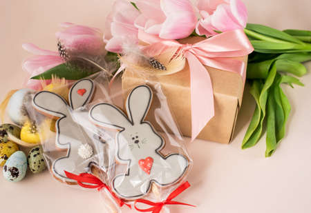 Beautiful Easter composition of eggs with natural colors, gingerbread, flowers, feathers. Holiday...