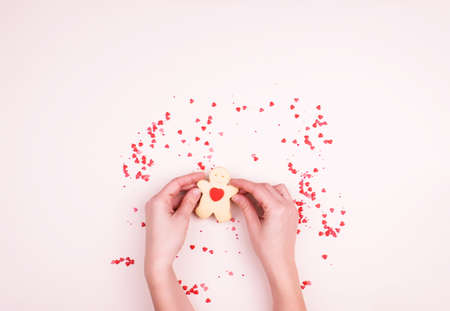 Shortbread cookies in the form of a man with a heart, a small decor of hearts, candy. A gentle...