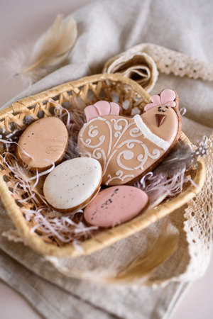 Beautiful Easter composition of eggs with natural colors, gingerbread, flowers, feathers. Holiday content.の写真素材