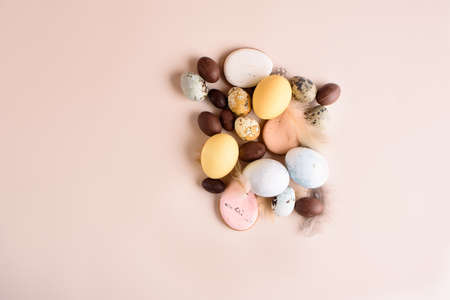 Beautiful Easter composition of eggs with natural colors, gingerbread, flowers, feathers. Holiday...
