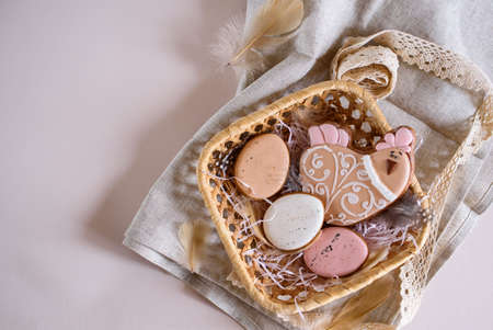 Beautiful Easter composition of eggs with natural colors, gingerbread, flowers, feathers. Holiday...