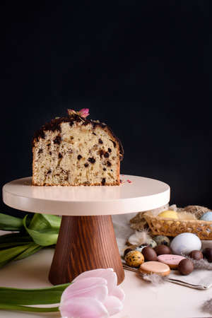 Beautiful Easter composition of eggs with natural colors, gingerbread, flowers, feathers. Holiday...