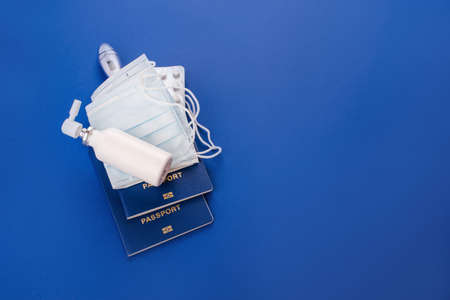 Drugs, face masks against viruses. Passports on a blue background. Quarantine. Covid-19の写真素材