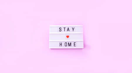 Light boxing with words stay at home on a pink background. Quarantine.の写真素材