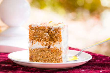 Beautiful and delicious honey cake in nature. Cutting the cake.