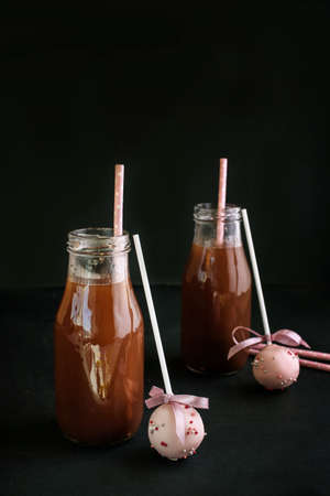 Delicious fragrant hot chocolate in glass jars, with drink tubes and a delicious dessert cake pops...