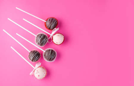 Composition of cake pops on a pink background with a different cream. Dessert on a stick. Tasty foodの写真素材