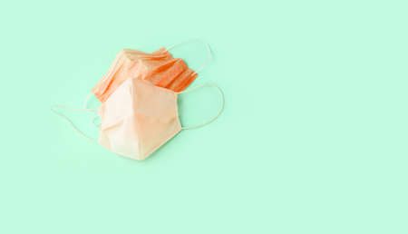 Two face masks of different shapes lie on a light background, with a place for inscription. Medetsin content.の写真素材