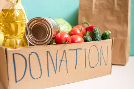 A box of fresh produce, vegetables, butter, stew, toilet paper for donation. Volunteer boxの写真素材
