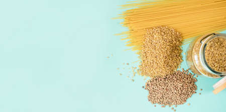 Fresh produce on a light background. Spaghetti, tomato, bulgur, stew, pepper, eco bag. View from...