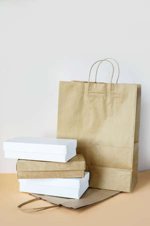 Delivery of food at home, in eco boxes and packages on a light background. Place for text