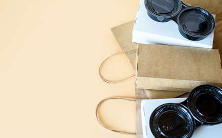 Delivery of food at home, in eco boxes and packages on a light background. Place for textの写真素材