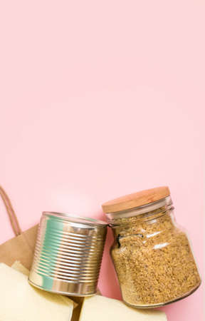 Craft package with grocery purchases. Toilet paper, cereals, a taus, on a light background. View from above, place for text.の写真素材