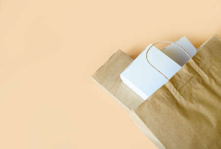 Delivery of food at home, in eco boxes and packages on a light background. Place for textの写真素材