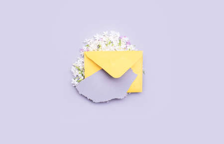 Content.Yellow envelope for a letter with lilac flowers. With a torn piece of paper for the text.の写真素材