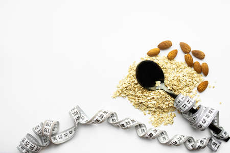 The spoon lies on top of dry oatmeal, and is wrapped in an inch. Healthy breakfast, diet, proper nutritio. Place for textの写真素材