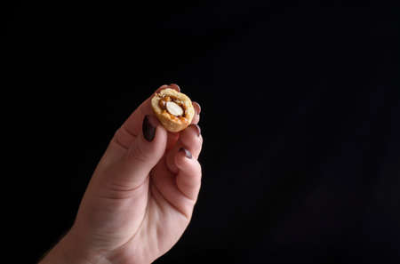 Homemade Russian nuts with condensed milk and mascarpone on a light blue background, wafer napkin. Cut nuts with condensed milk. Bitten goodies for tea. Condensed Nutsの写真素材