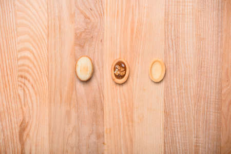 Homemade Russian nuts with condensed milk on a light pink background, wafer napkin. Cut nuts with condensed milk. Bitten goodies for coffee. Condensed Nuts. Place for text.の写真素材