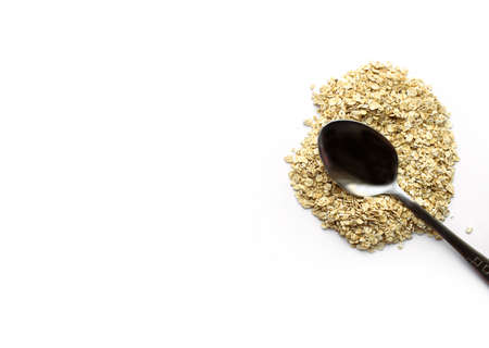 The spoon lies on top of dry oatmeal. Healthy breakfast, diet, proper nutritio. Place for text. Flat layの写真素材