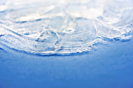 Transparent face mask with particles of natural components. Gel face mask on a blue background.の写真素材