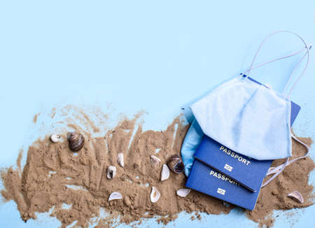 Beach sand on a blue background with wood letters and a word staycation. Holiday at home