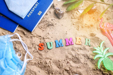 Beach sand with toys for the baby, water, the word summer in colored letters. Staycation contentの写真素材