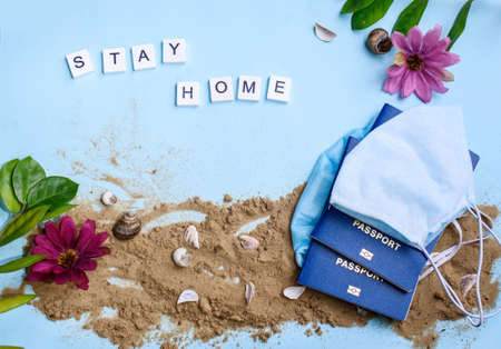 Beach sand on a blue background with wood letters and a word staycation. Holiday at homeの写真素材