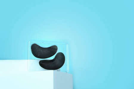 Black eye patches stand on the podium , against a bright blue background. A place for text....