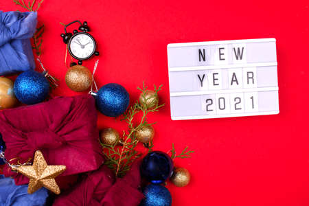 Light screen with the inscription New Year 2021. Gifts, toys, we have red background. Bokeh, furoshiki.の写真素材