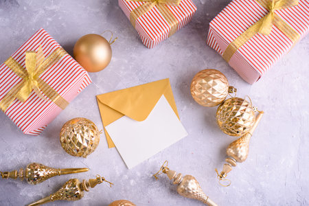 Beautiful Christmas gifts, gold toys on the Christmas tree, yellow contert and white sheet for...