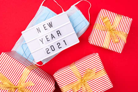 New Years gifts with beautiful decor, face masks, light boxing with new years writing. New year 2021 awareness.の写真素材
