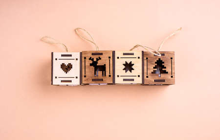 Wooden eco toys on the Christmas tree. In the form of lanterns and houses. New Years content. View...