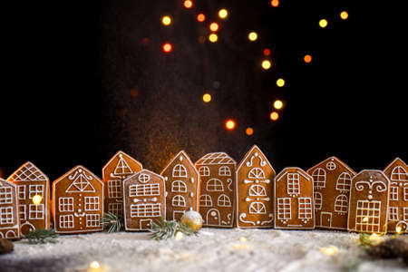 Winter gingerbread house with light from the windows, gingerbread city, big side lights, snow. New Years content.の写真素材