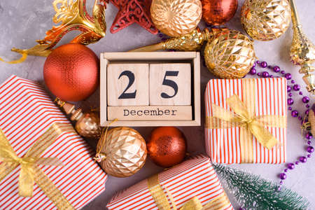 New Years content, Christmas tree gold toys, a small Christmas tree, lights, wood eco cubes with the...