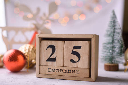 New Years content, Christmas tree gold toys, a small Christmas tree, lights, wood eco cubes with the figure on December 25.の写真素材