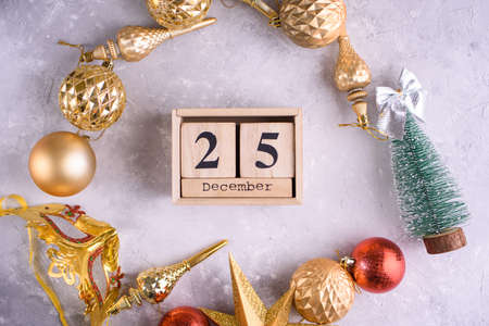 New Years content, Christmas tree gold toys, a small Christmas tree, lights, wood eco cubes with the figure on December 25.の写真素材