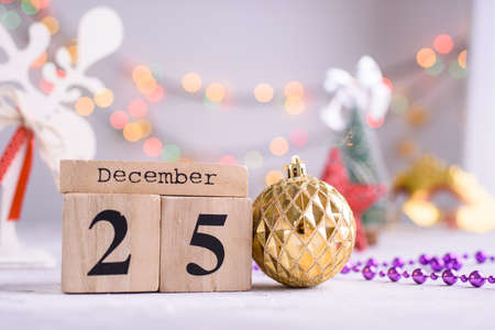 New Years content, Christmas tree gold toys, a small Christmas tree, lights, wood eco cubes with the...