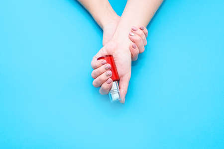 Beautiful womans hands on the pink background. Well-groomed female hands with a beautiful manicureの写真素材