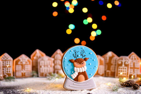 Winter gingerbread house with light from the windows, gingerbread city, big side lights, snow. New Years content.の写真素材