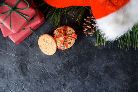 Delicious shortbread cookies with pieces of chocolate, with red ribbon, a sprig of spruce, Santas...