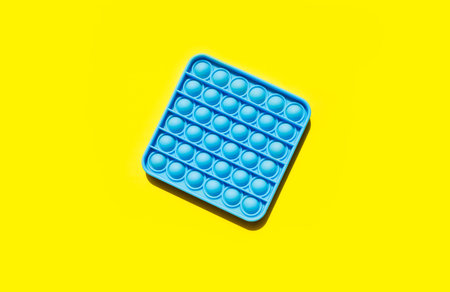 Close up shot of pop pt fidget toy. Instrument for fine motoric skils, tool to start counting, learn primary arithmetic operations. trend toyの写真素材