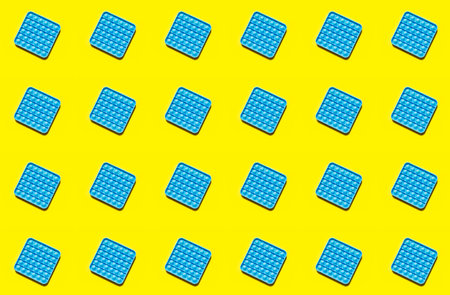 Close up shot of pop pt fidget toy. Instrument for fine motoric skils, tool to start counting, learn primary arithmetic operations. Trend toy. Patternの写真素材