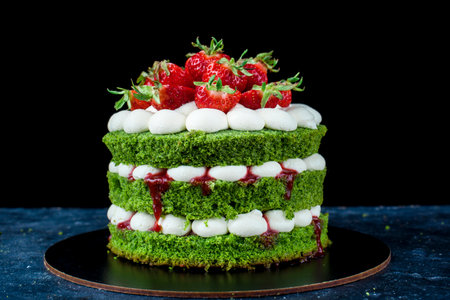 Delicious schnipinat cake with cream, and strawberries on the dark background. The creation process. Natural products for cake.の写真素材