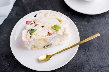 Mereng cake with fresh berries and fruits. Strawberries, kiwi, blackberries. protein dessert in...