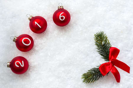 2016 Christmas balls and fir branch on snow background with space for your text.の写真素材